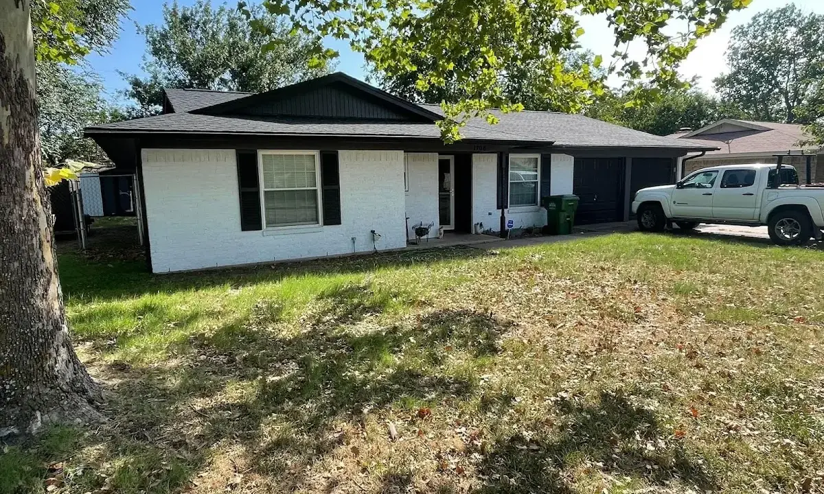 Professional roofing crew working on a residential roof in Cranford
